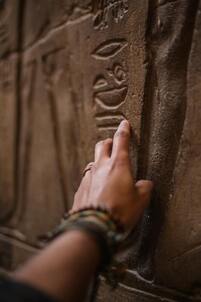 Image of a hand on hieroglyphs